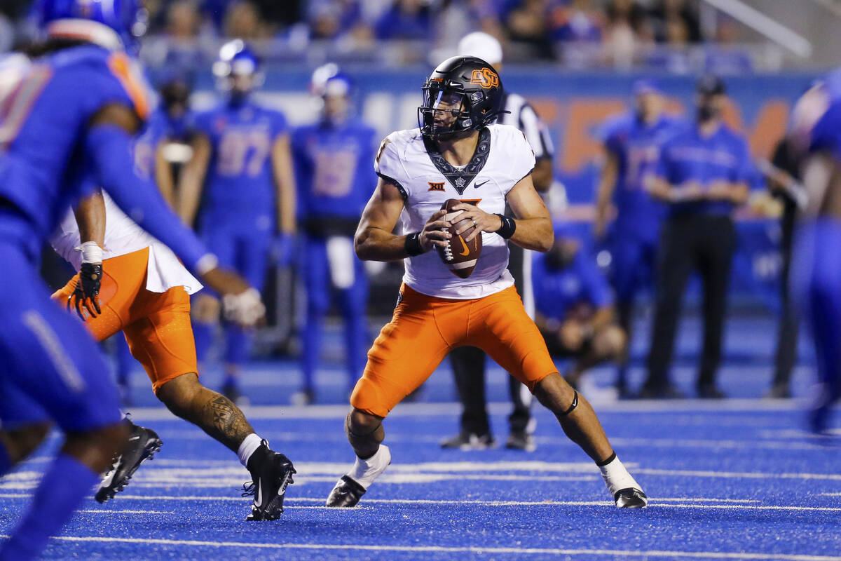 Oklahoma State quarterback Spencer Sanders drop back during the second half of the team's NCAA ...