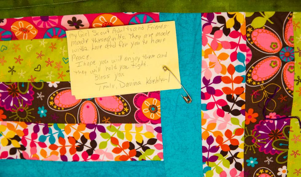 A donated quilt is seen from a group of Girl Scouts that will be given away to survivors, rela ...