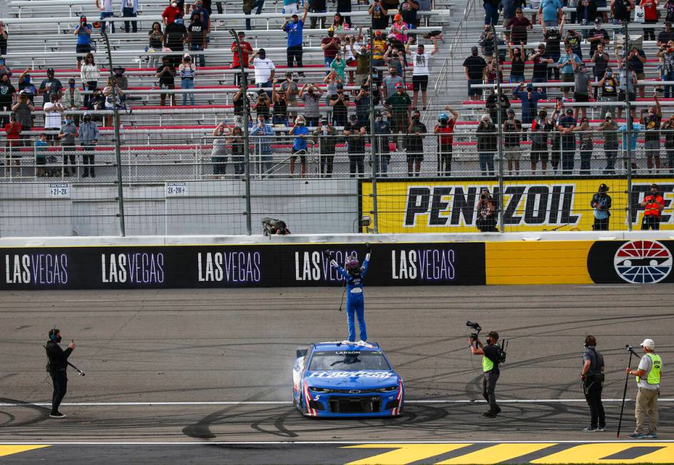 Kyle Larson, center, celebrates after winning the NASCAR Cup Series Pennzoil 400 auto race at t ...