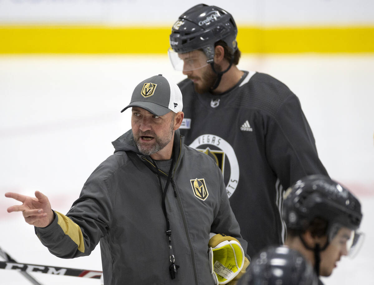 Head coach Peter DeBoer speaks to the team during a NHL hockey training camp practice at City N ...