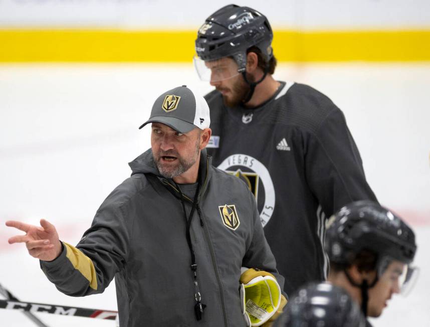 Head coach Peter DeBoer speaks to the team during a NHL hockey training camp practice at City N ...