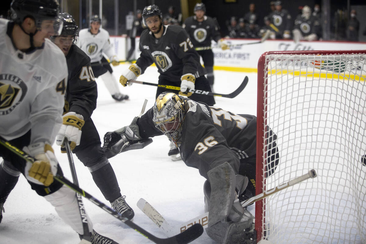 Golden Knights goaltender Logan Thompson (36) falls back as he lets a goal in the net during a ...