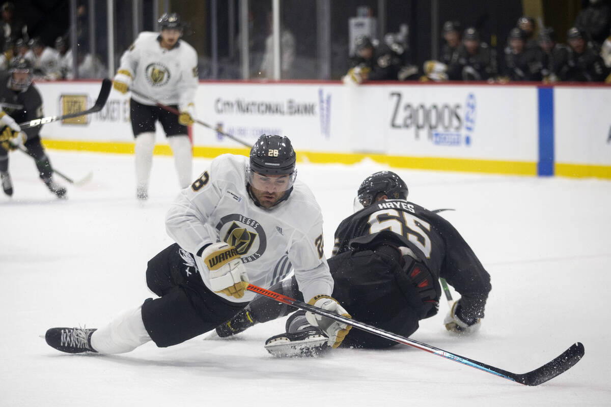 Golden Knights left wing William Carrier (28) and defenseman Zack Hayes (65) fall to the ice du ...