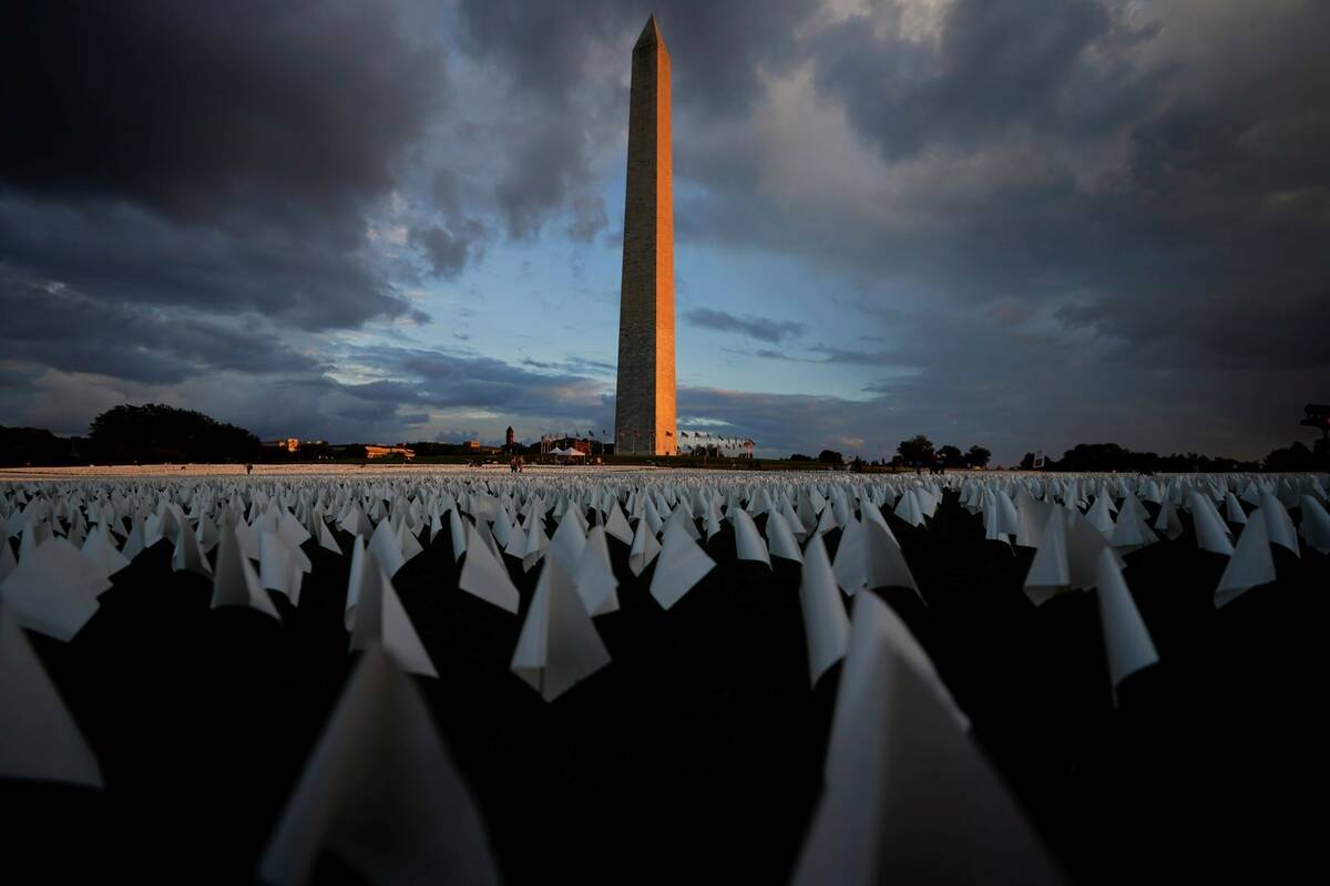 With the Washington Monument in the background, white flags are displays as part of artist Suza ...