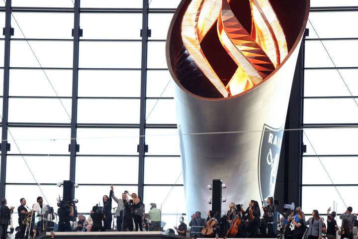 Former Nevada Gov. Brian Sandoval lights the Al Davis Memorial Torch before an NFL football gam ...