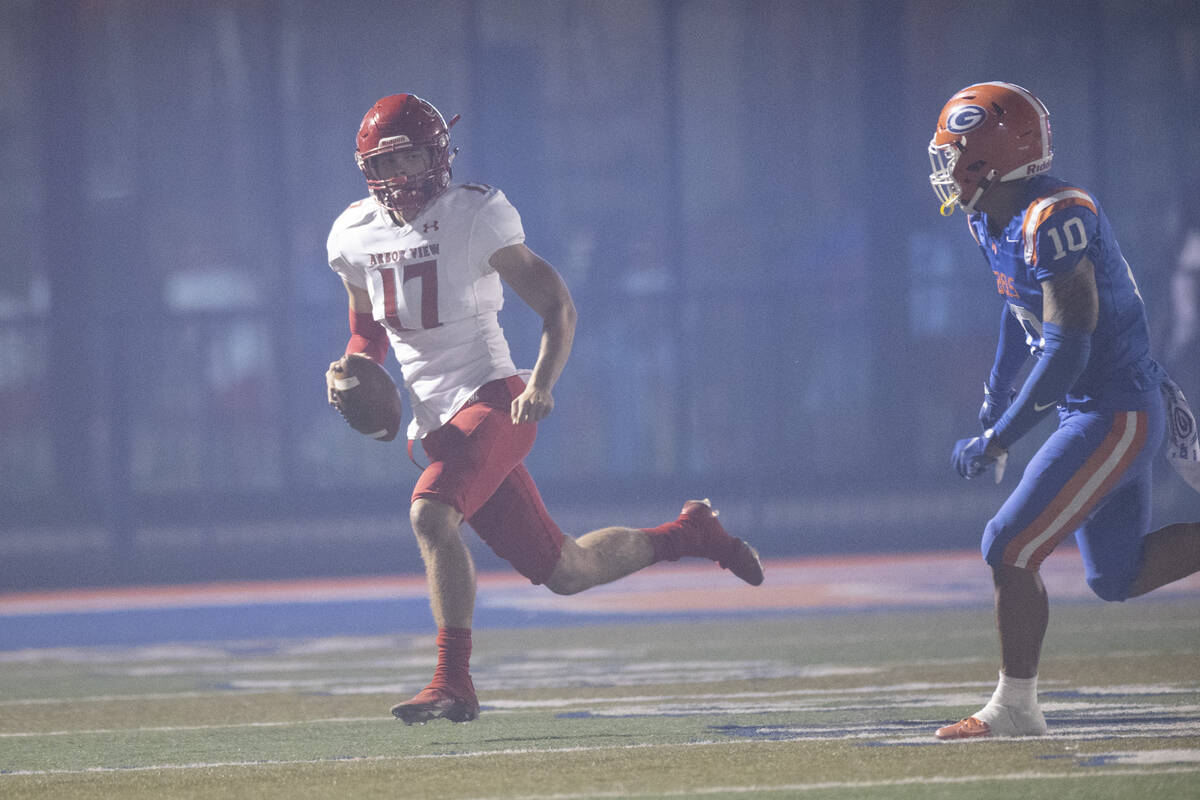 Arbor View's Kyle Holmes (17) is pressured out of bounds by Bishop Gorman's Palaie Faoa (10) du ...