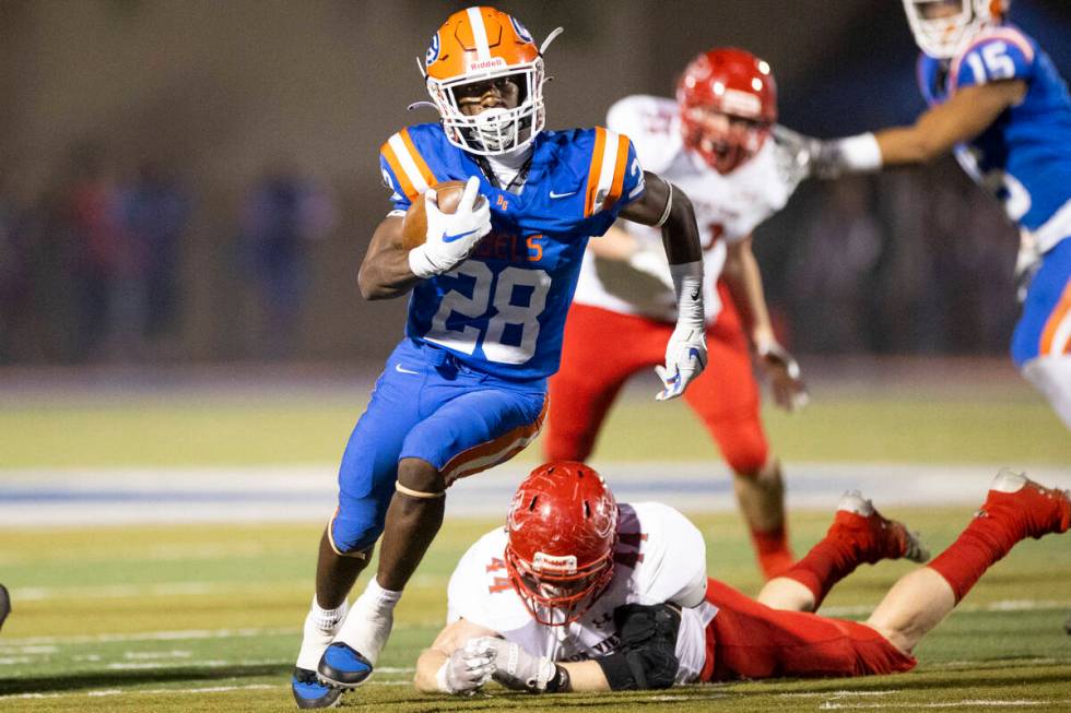 Bishop Gorman's Devon Rice (28) runs the ball against Arbor View in the first half of a footbal ...