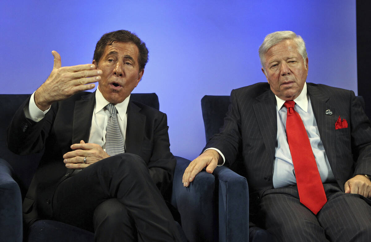 Casino mogul Steve Wynn, left, talks as New England Patriots owner Robert Kraft, right, listens ...
