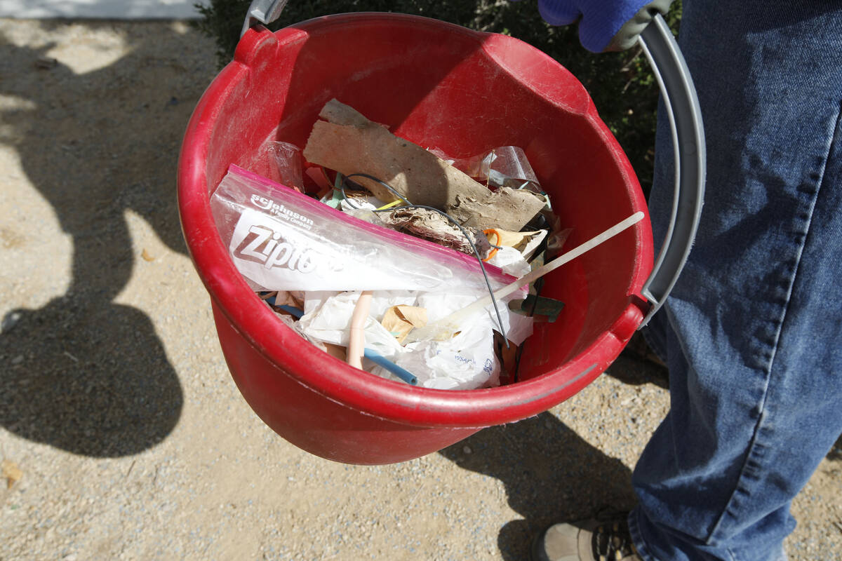 Erik Delmar from The Venetian Resort shows trash he picked up during a park cleanup, Saturday, ...