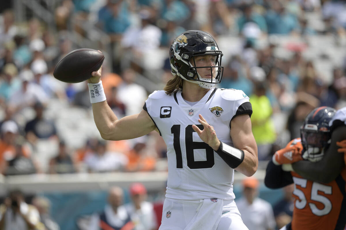 Jacksonville Jaguars quarterback Trevor Lawrence (16) throws a pass during the first half of an ...