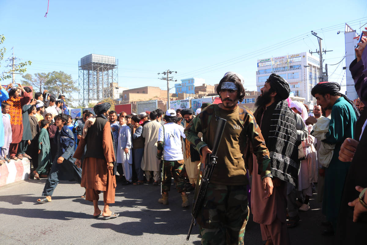 People gather in the main square of Herat city in western Afghanistan, where the Taliban hanged ...