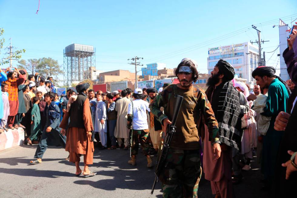 People gather in the main square of Herat city in western Afghanistan, where the Taliban hanged ...