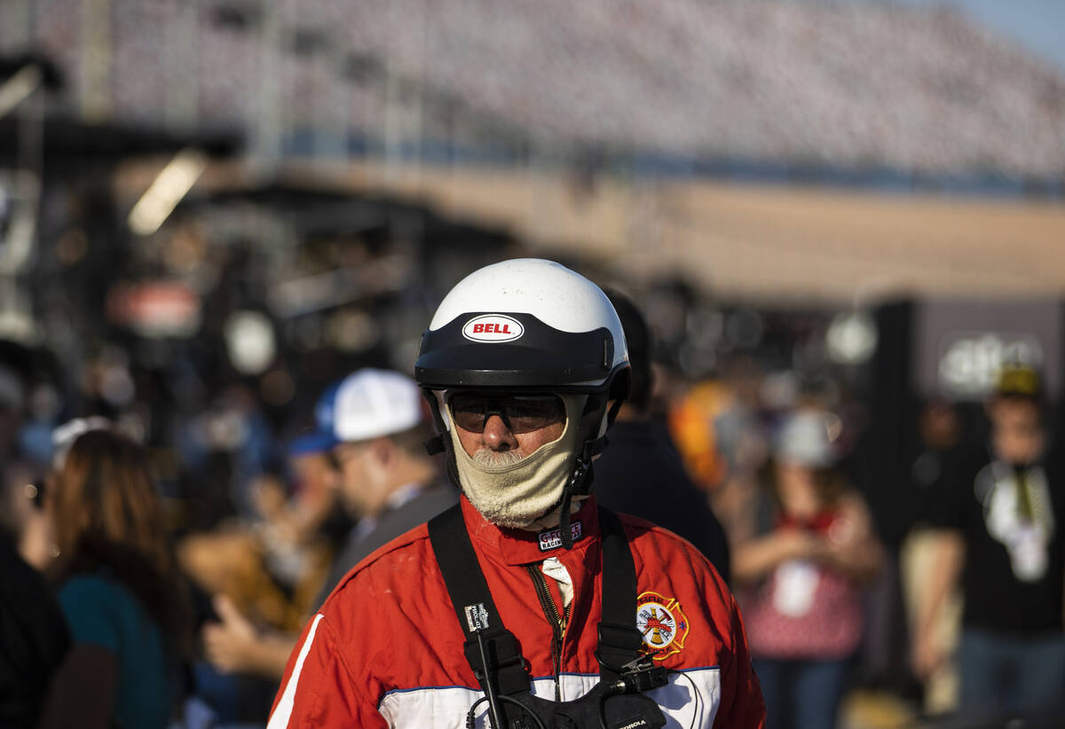 Safety crews walk in the pit area during the Alsco Uniforms 302 NASCAR Xfinity series race on S ...