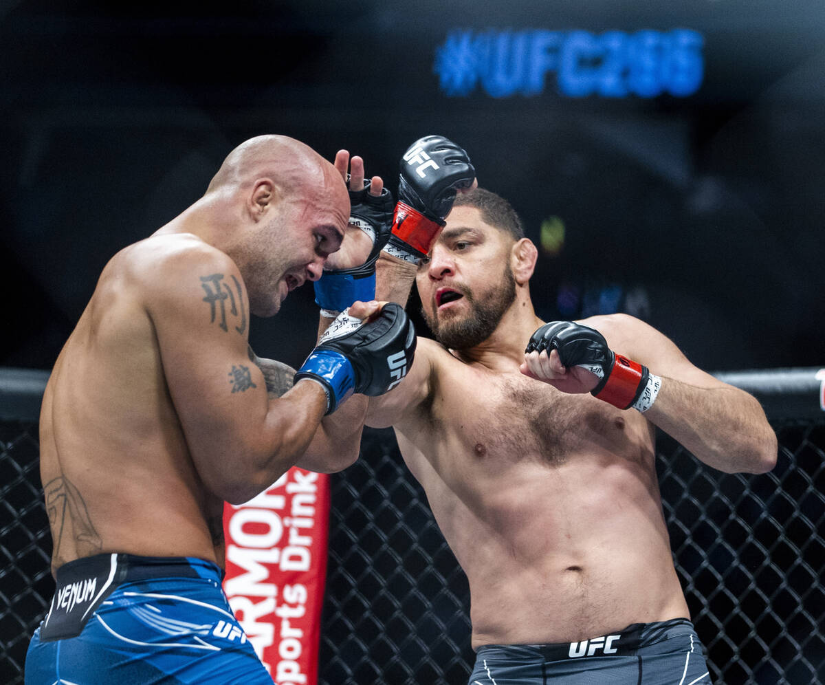Robbie Lawler, left, takes a punch from Nick Diaz in the second round during their welterweight ...