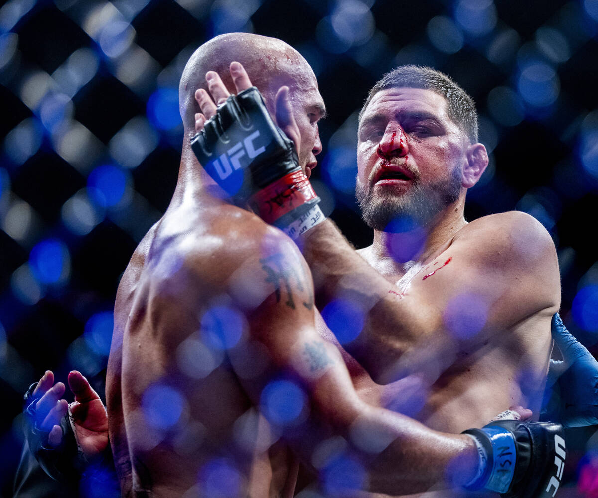 Robbie Lawler, left, and Nick Diaz embrace after Lawler wins their welterweight fight in UFC 26 ...