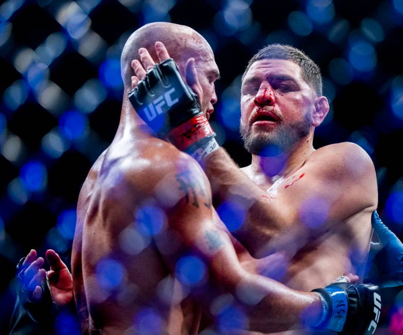 Robbie Lawler, left, and Nick Diaz embrace after Lawler wins their welterweight fight in UFC 26 ...
