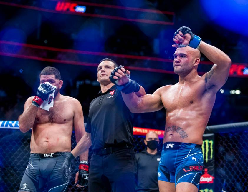 Robbie Lawler, right, and Nick Diaz after Lawler wins their welterweight fight in UFC 266 at T- ...