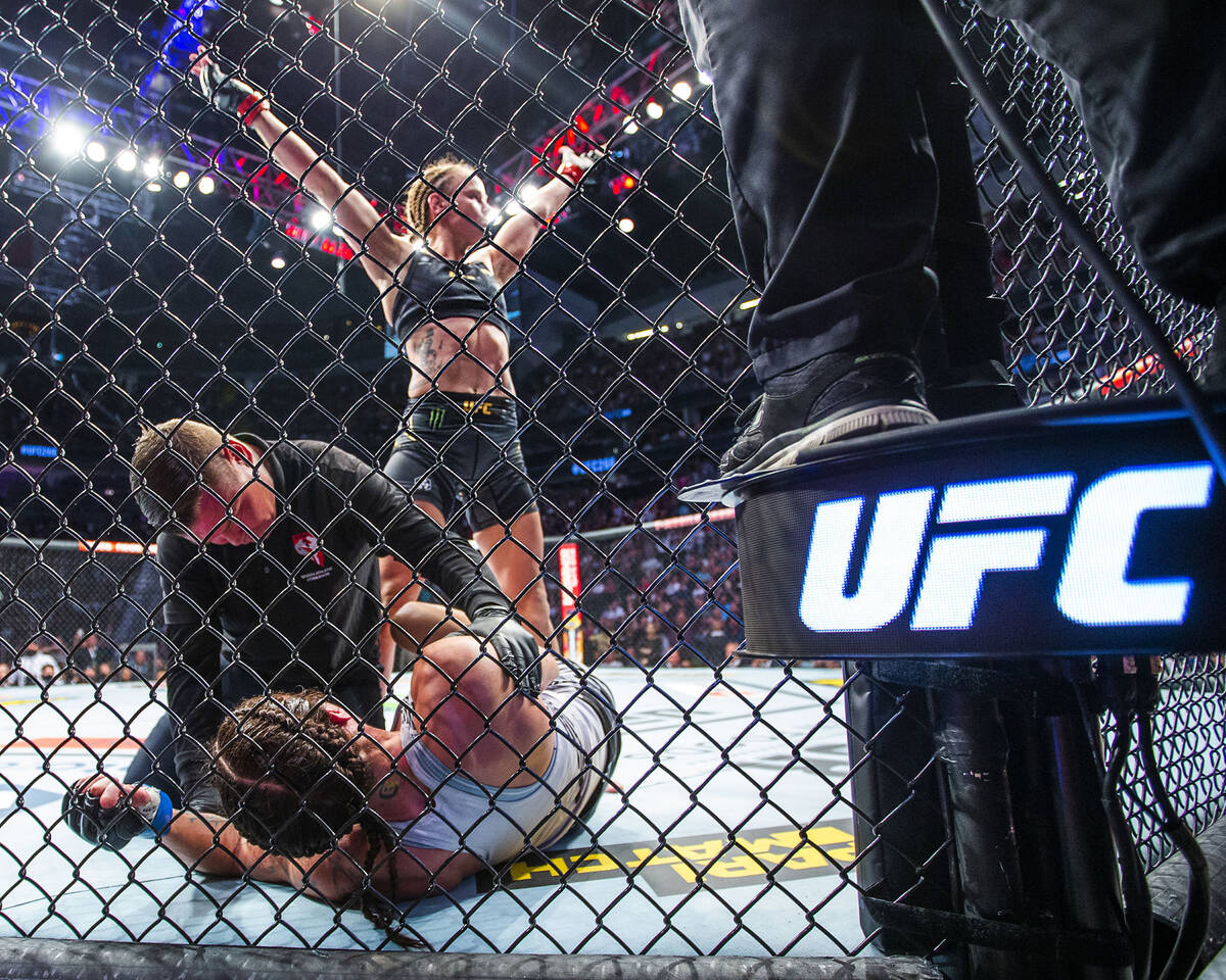 Valentina Shevchenko, above, celebrates her knock out of Lauren Murphy being checked by a refer ...