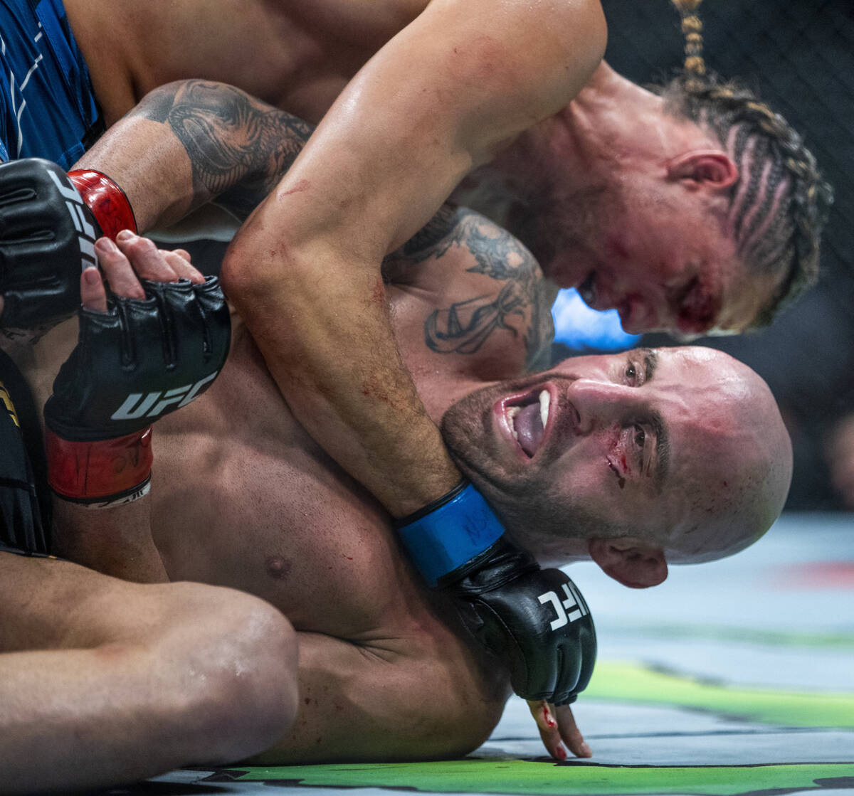 Alexander Volkanovski, bottom, yells out as Brian Ortega gets position in the third round durin ...