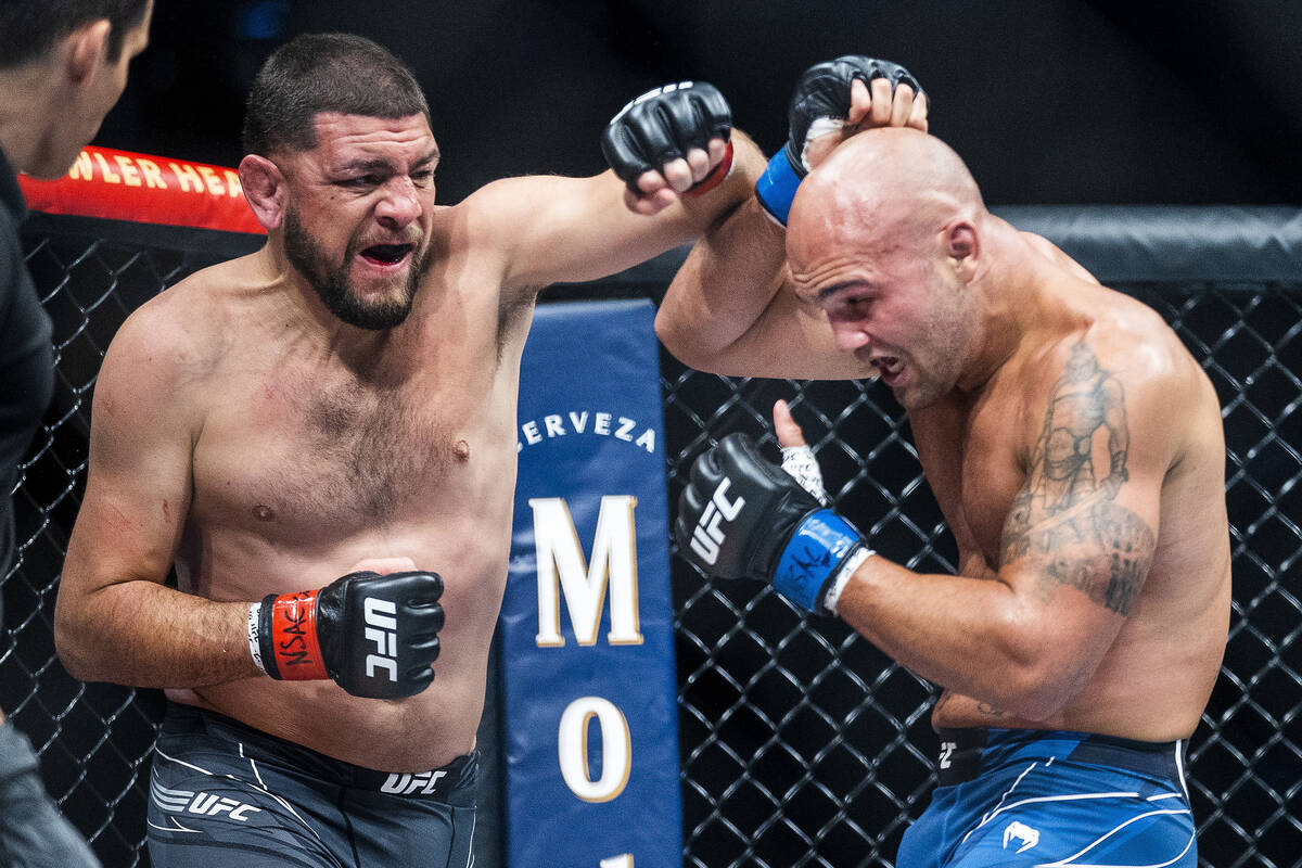 Nick Diaz, left, battles with Robbie Lawler in the third round during their welterweight fight ...