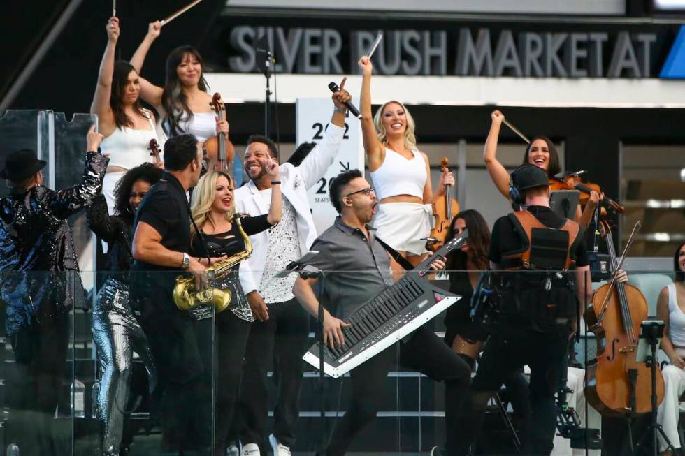 Otto Ehling (with keytar) and David Perrico's Pop Strings band perform at Allegiant Stadium in ...