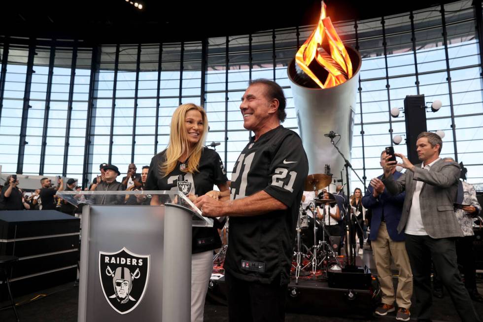 Steve Wynn lights the Al Davis Memorial Torch with his wife Andrea Hissom before the Raiders ta ...