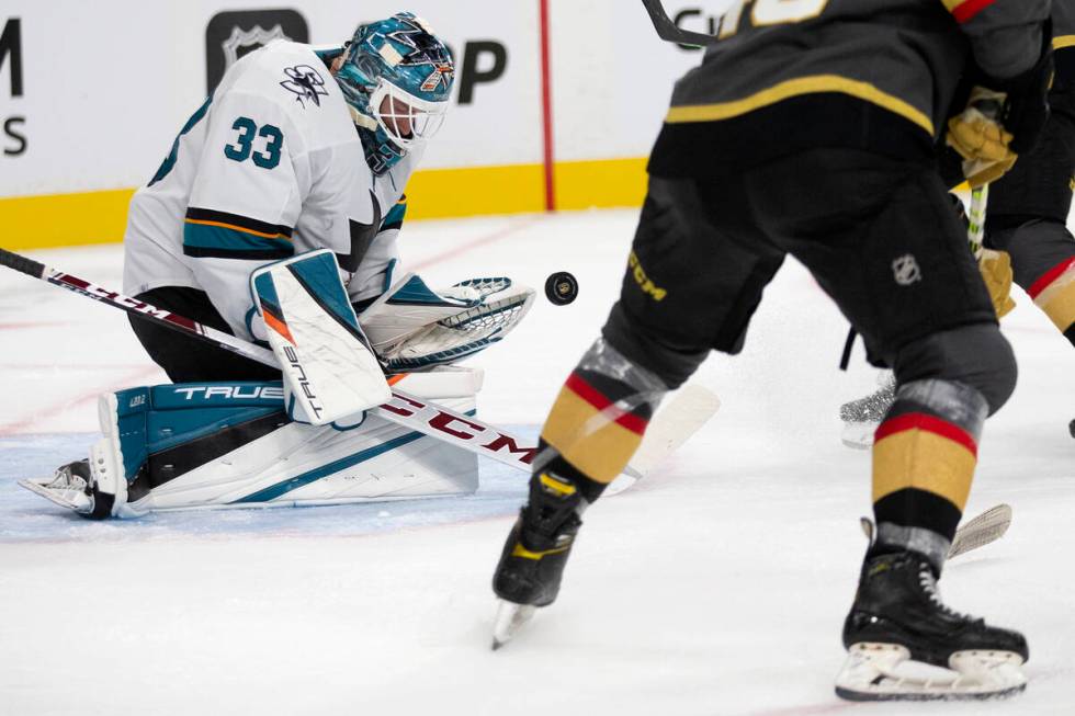 Sharks goaltender Adin Hill (33) saves a shot during the third period of a preseason NHL hockey ...