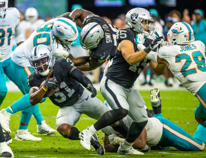 Las Vegas Raiders running back Peyton Barber (31) eyes the end zone on a run past Miami Dolphin ...