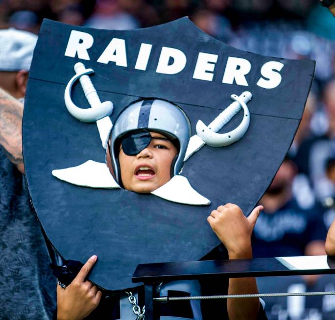 A young Raiders fan wears a homemade shield versus the Miami Dolphins in the first half of thei ...