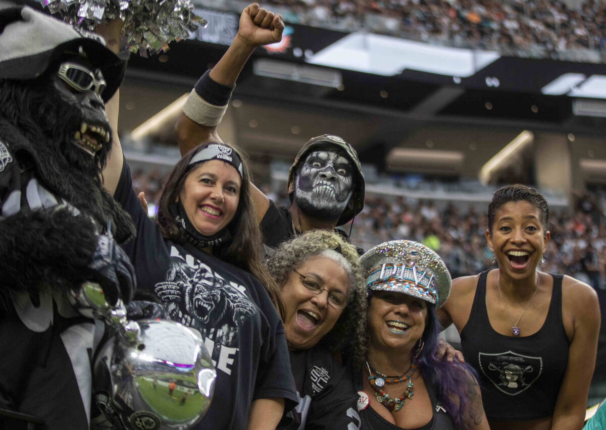 Raiders fans cheer during the fourth quarter of an NFL football game against the Miami Dolphins ...