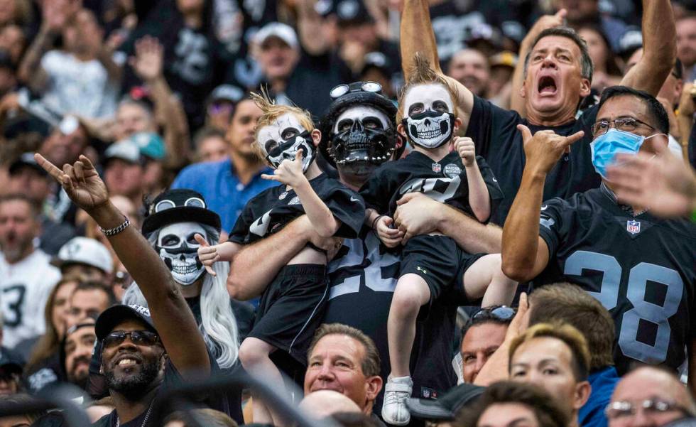 Raiders fans cheer on the team versus the Miami Dolphins in the first half of their NFL game at ...