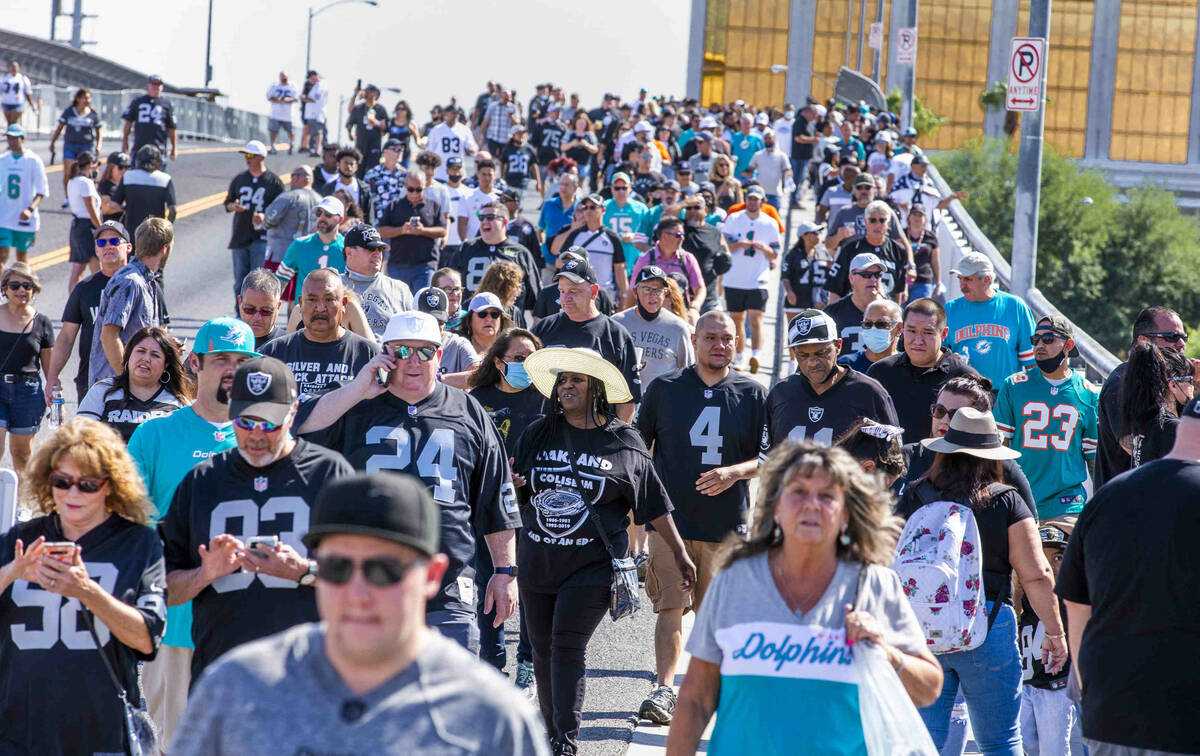 Fans walk across the Hacienda Avenue bridge as the Raiders will face the Miami Dolphins for the ...