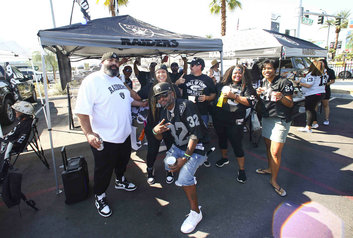 Raiders fans pose for a picture during a tailgate before an NFL game between the Raiders and Mi ...