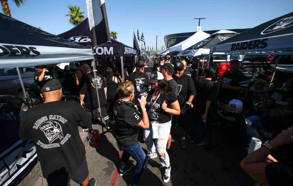 Raiders fans dance and tailgate before an NFL game between the Raiders and Miami Dolphins at Al ...