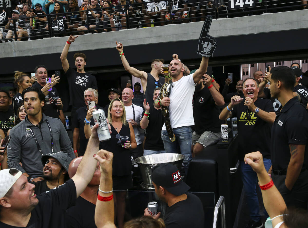 UFC fighter Alexander Volkanovski celebrates while taking in the action between the Raiders and ...