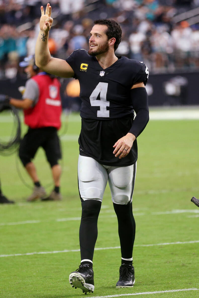 Las Vegas Raiders quarterback Derek Carr (4) raises his arms as he leaves the field in the sec ...