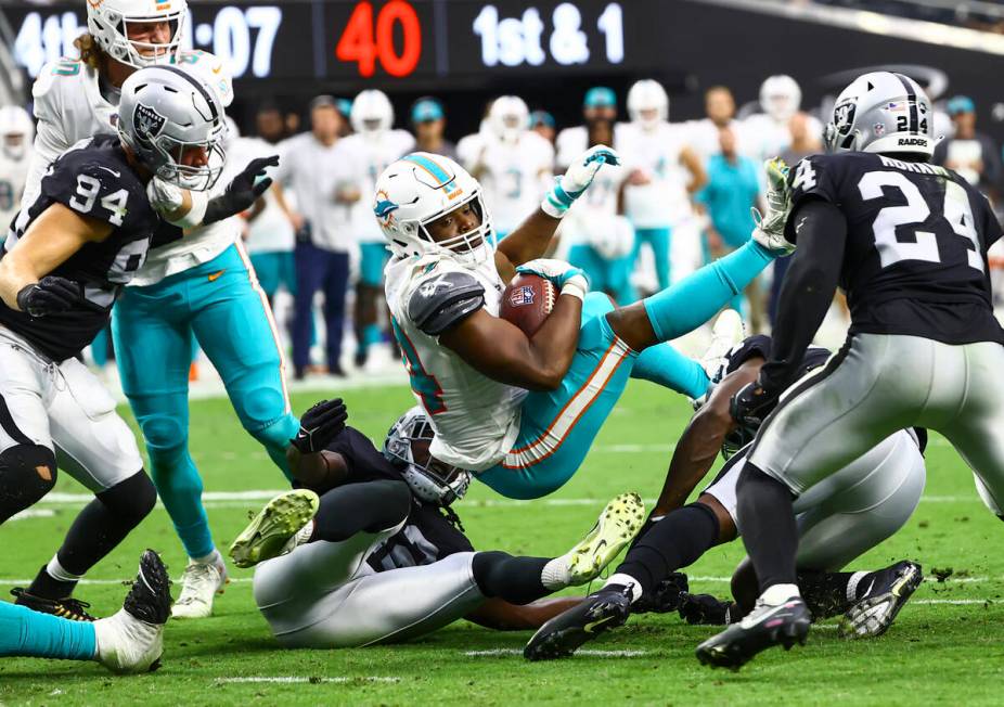 Miami Dolphins quarterback Jacoby Brissett (14) is stopped short at the end zone by the Raiders ...