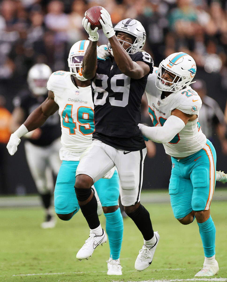 Las Vegas Raiders wide receiver Bryan Edwards (89) makes catch under pressure from Miami Dolphi ...