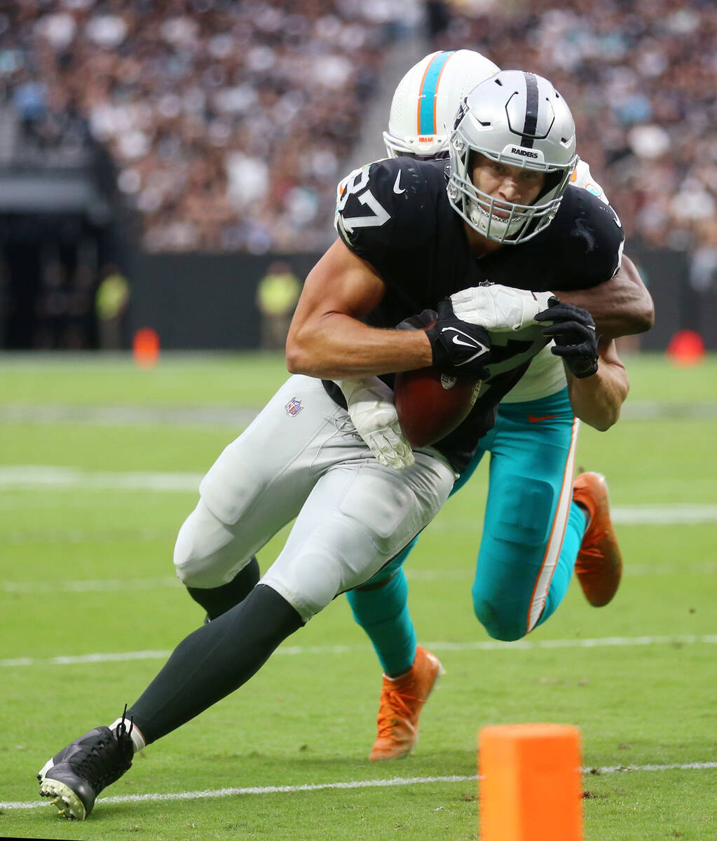 Las Vegas Raiders tight end Foster Moreau (87) is tackled by Miami Dolphins free safety Eric Ro ...