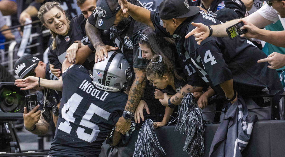 Las Vegas Raiders fullback Alec Ingold (45) jumps into the stands to celebrate his touchdown wi ...
