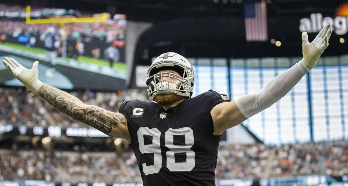 Las Vegas Raiders defensive end Maxx Crosby (98) salutes the crowd in the first half during an ...