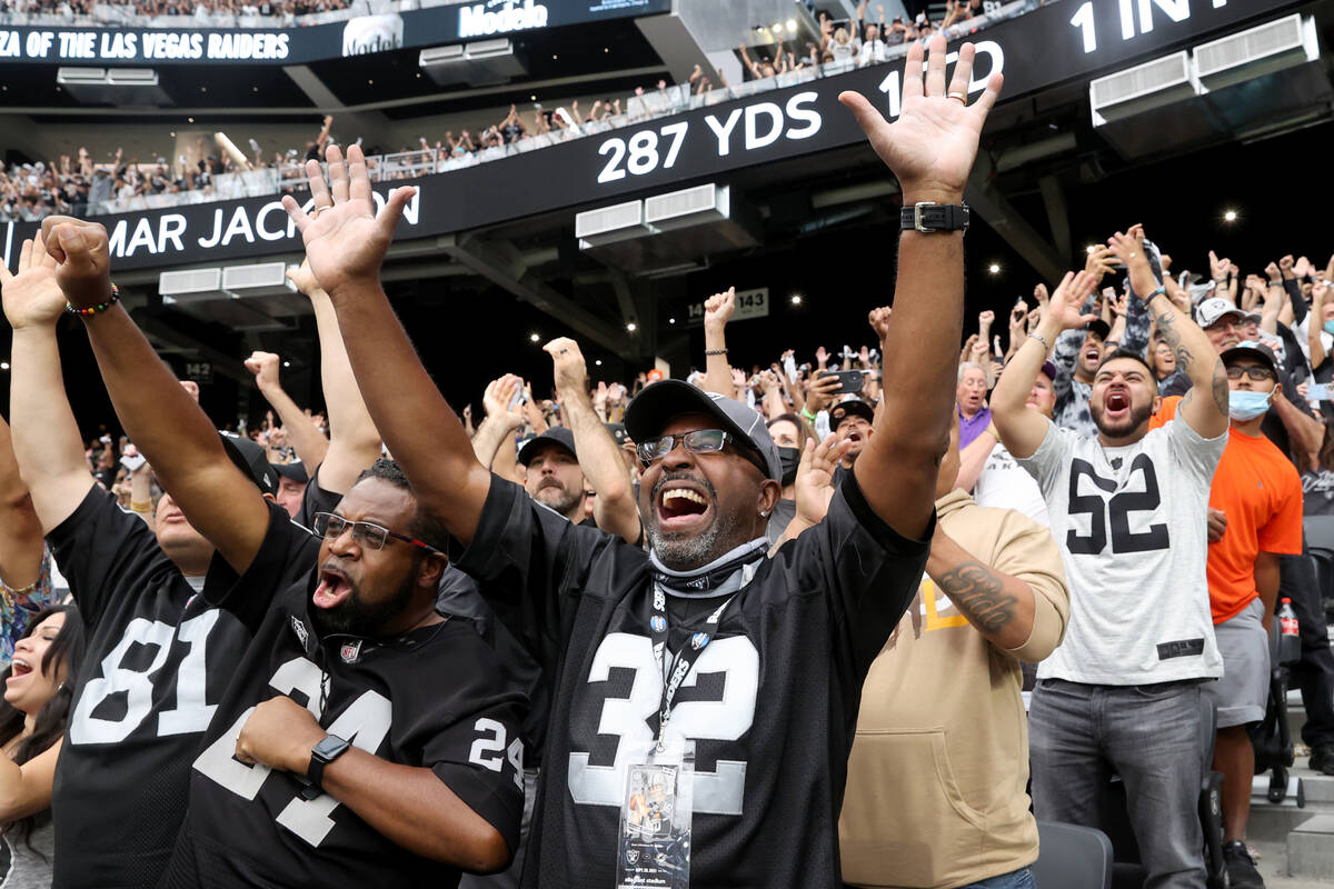 Fans, including Lorenzo Smith, right and patrick Manning, both of Oakland, cheer as the Raiders ...
