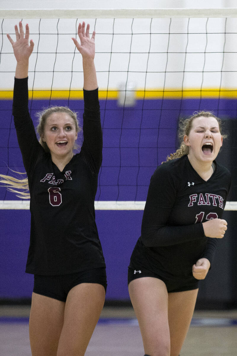 Faith Lutheran's Bianca Richardson (6) and Delaney Wilson (12) celebrate a point scored during ...