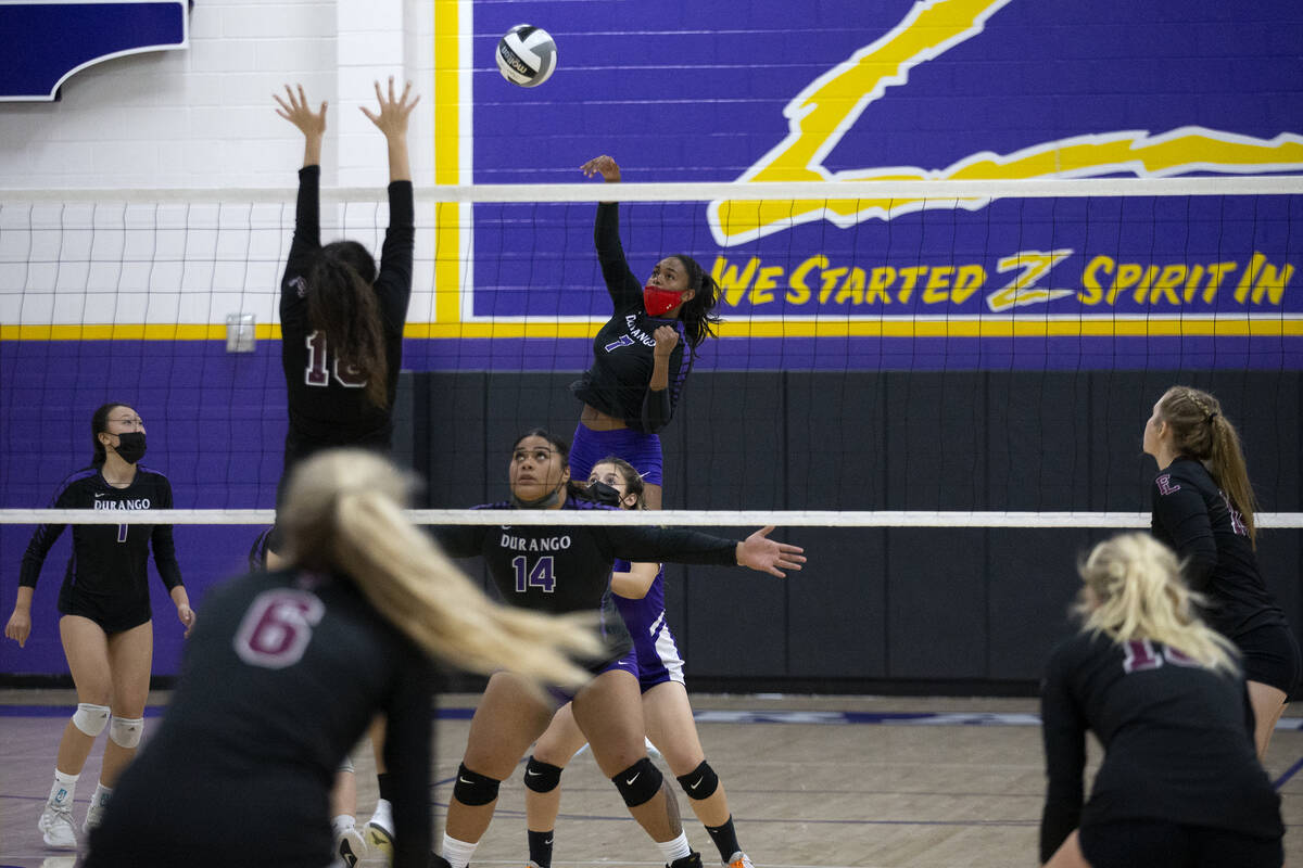 Durango's Sydney Wilkes (7) spikes as Faith Lutheran's Haylee Strong (18) jumps to kill during ...
