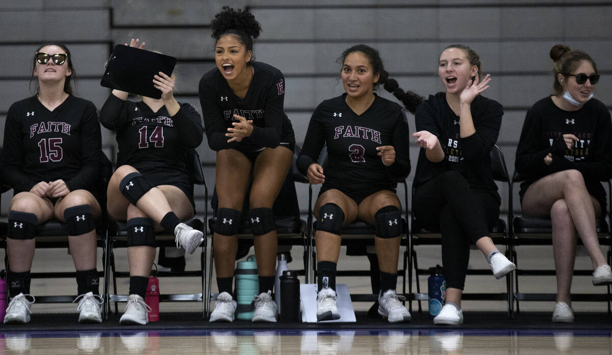 Faith Lutheran's bench cheers for their team during a high school volleyball game against Duran ...