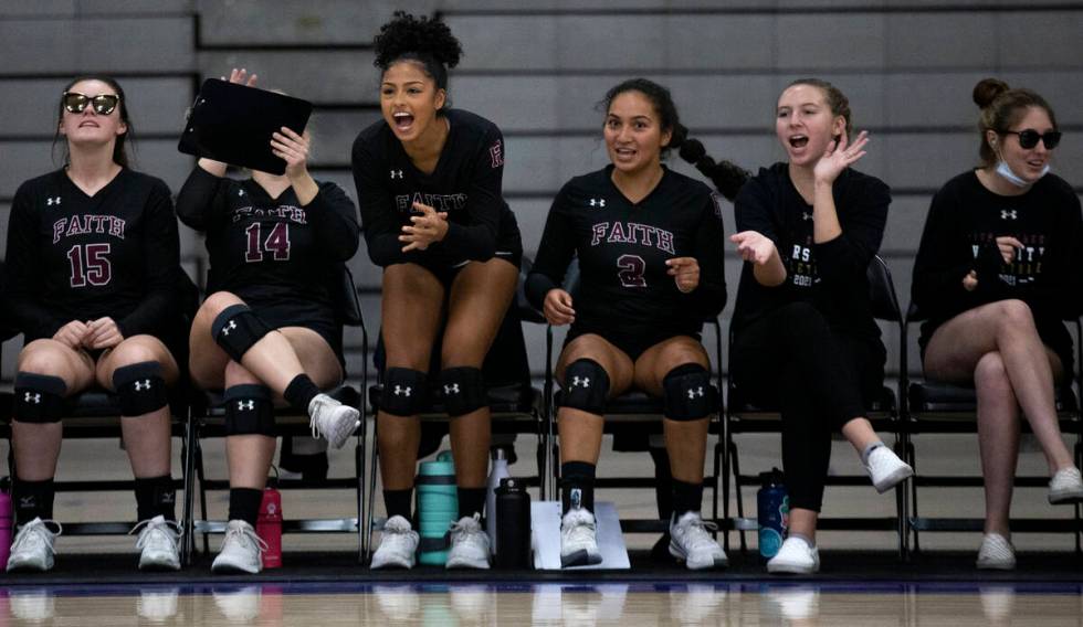 Faith Lutheran's bench cheers for their team during a high school volleyball game against Duran ...