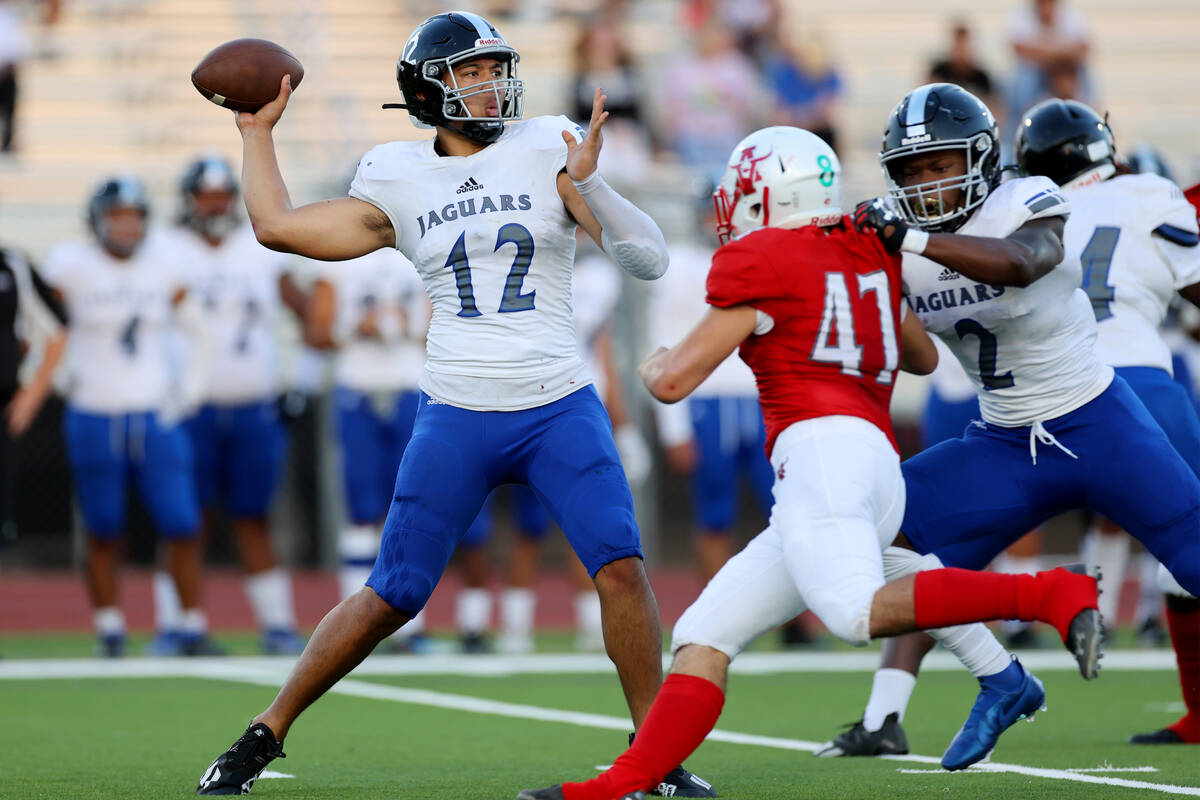 Desert Pines Rjay Tagataese (12) throws a touchdown pass against Arbor View in the first half o ...