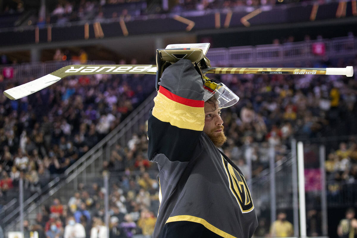 Golden Knights goaltender Laurent Brossoit (39) puts his helmet back on during the first period ...