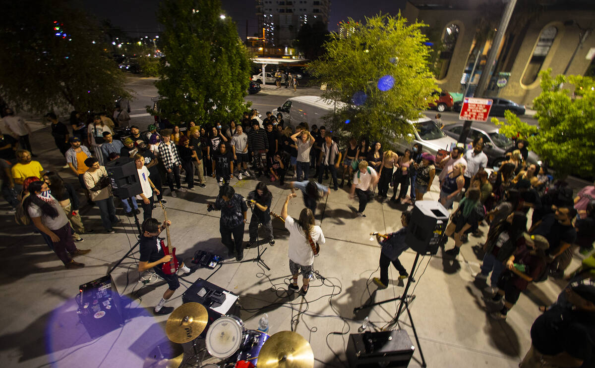 People watch as Ugly Boy, a band from east Las Vegas, performs during First Friday in the Arts ...