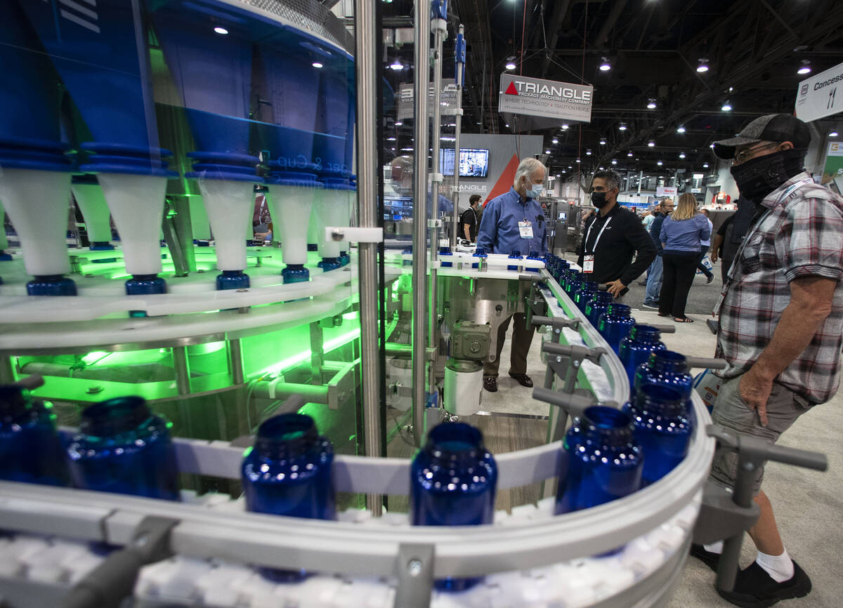 Richard Laforest, left, of Spee-Dee Packaging Machinery Inc., talks about a rotary filling mach ...